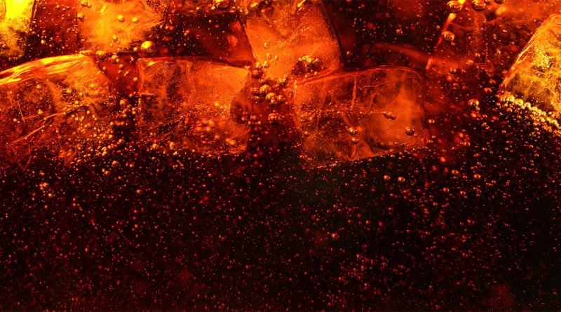 Close-up image of Coca-Cola in a glass with various chunks of ice and bubbles to support Coca-Cola's strategy article