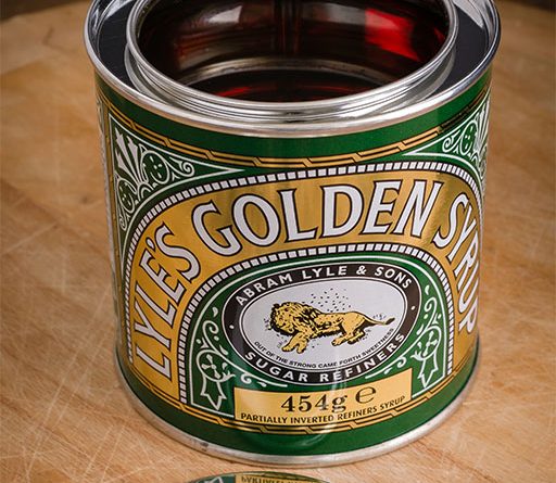 Close-up image of a bottle of Lyle's Golden Syrup, displaying their new logo