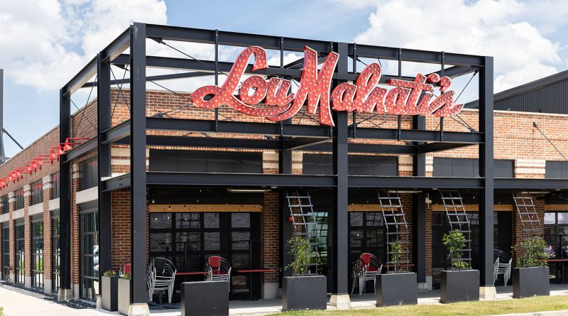 Lou Malnati’s deep dish pizza served in a pan on a rustic wooden table