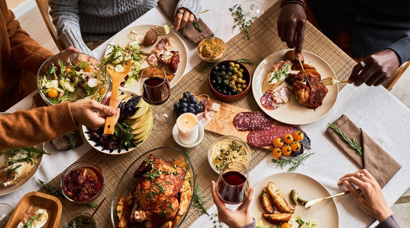 A Thanksgiving table filled with classic side dishes including stuffing, mashed potatoes, and green bean casserole