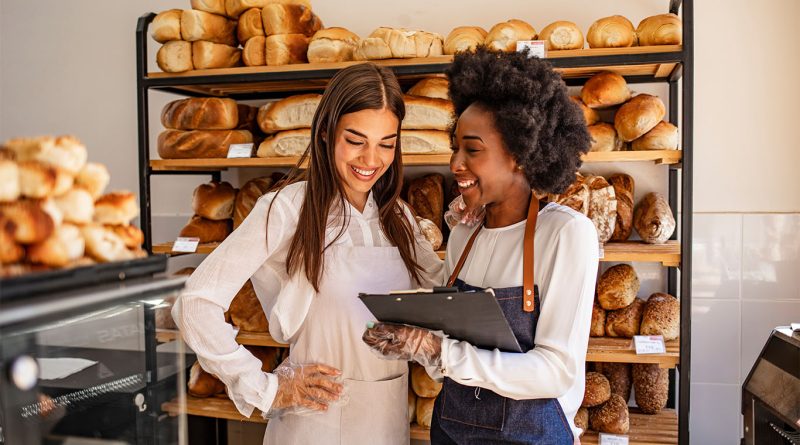 Young food entrepreneurs presenting packaged products at a startup showcase event