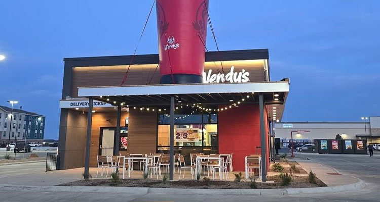 a modern Wendy's restaurant building at dusk or dawn.